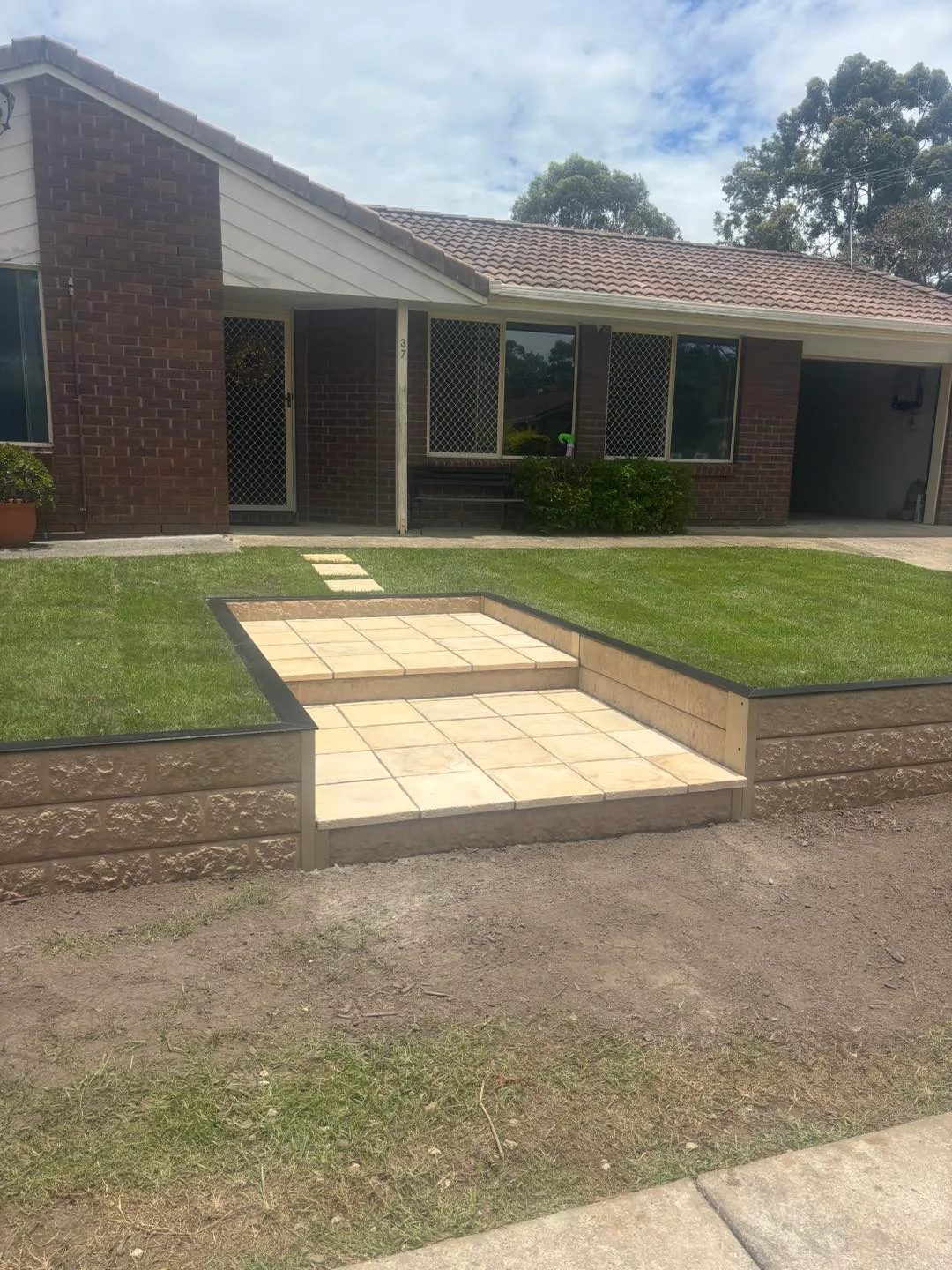 Colorbond fence opening onto an outdoor entertaining area