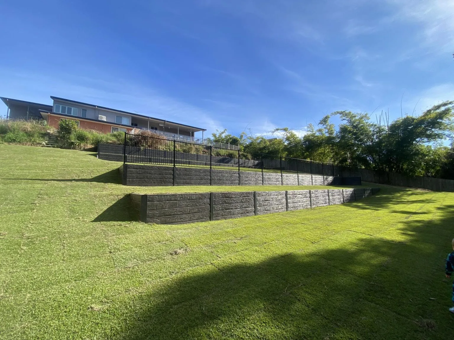 Landscaped retaining wall and garden lighting at dusk