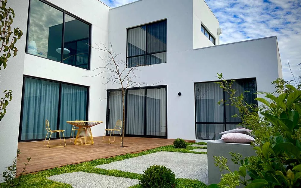 Timber deck with outdoor dining setting and established garden beds