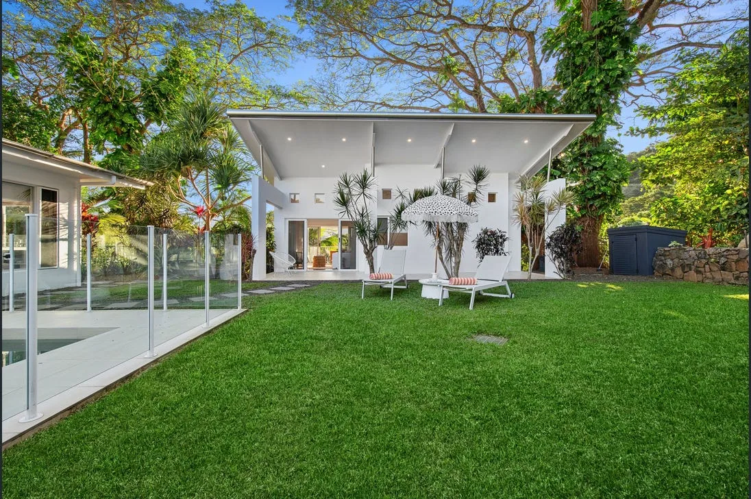 Backyard with pool, deck and established landscaping