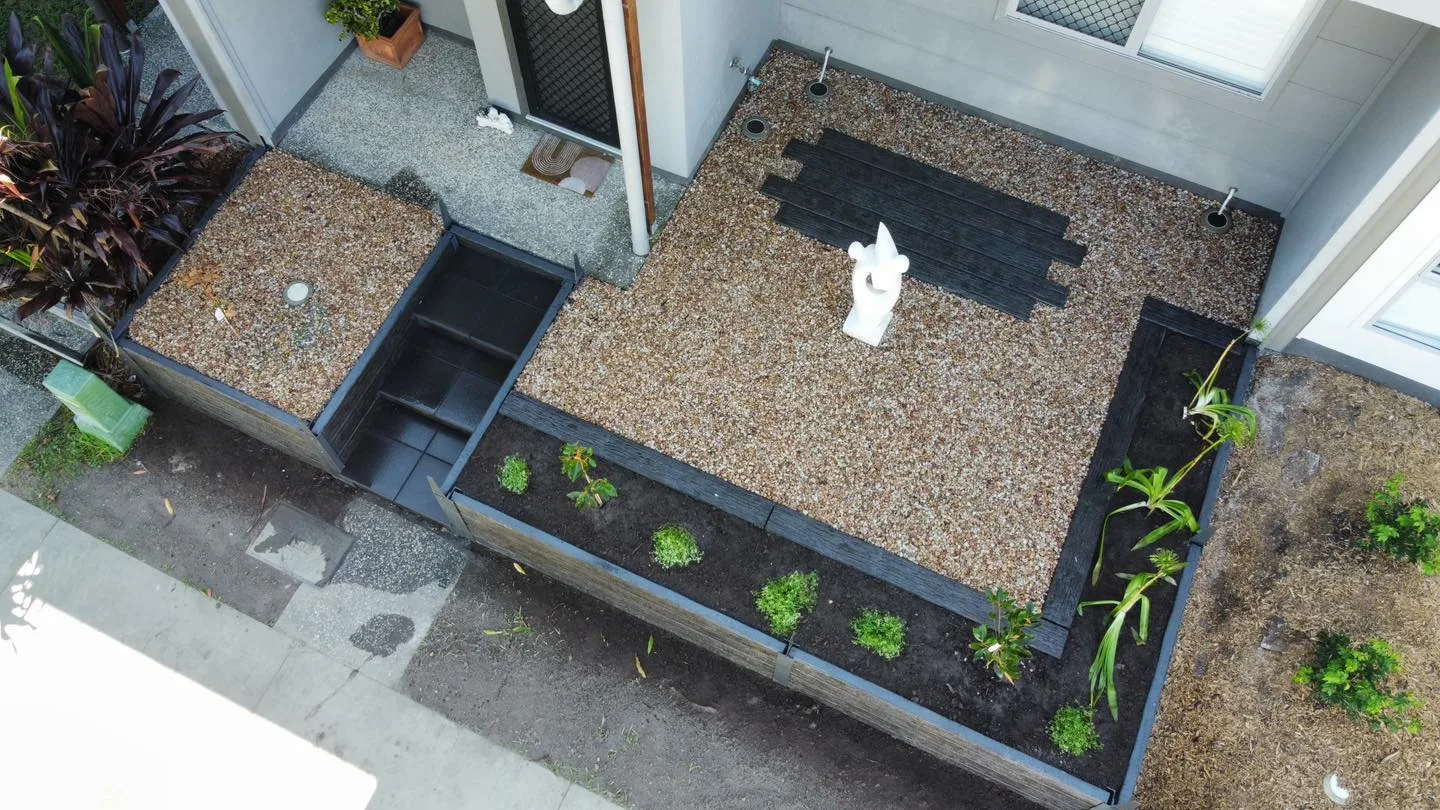 Aerial view of a completed paved courtyard with garden beds