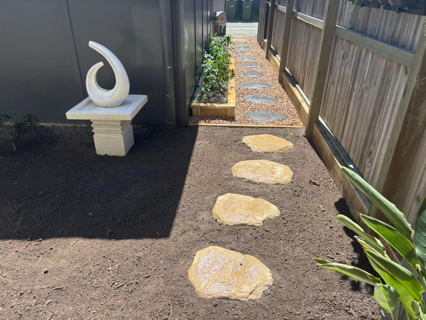 Paved garden path through established landscaping
